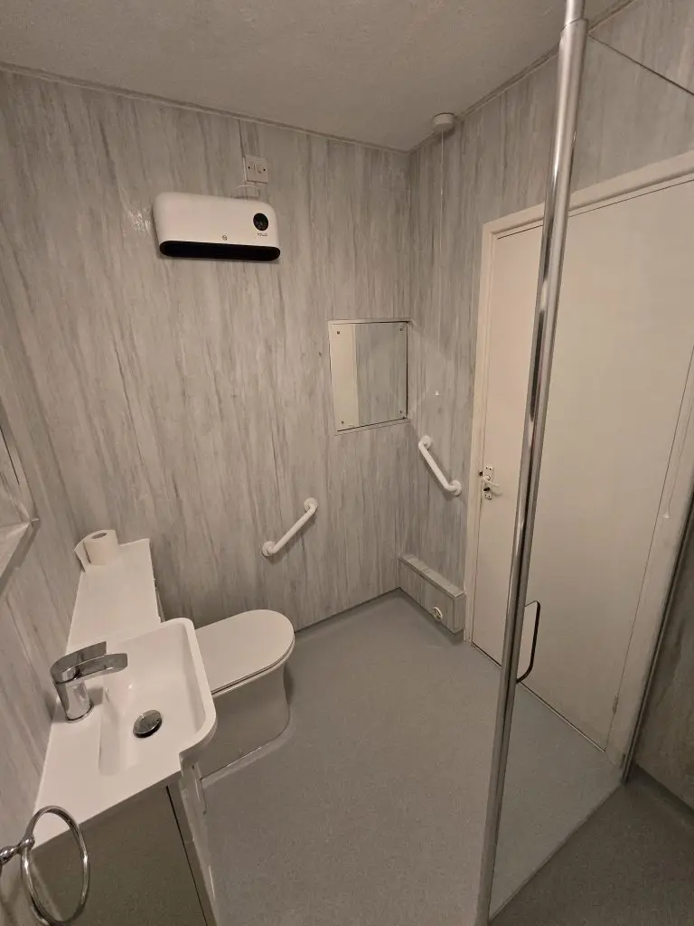 A wet room with non-slip Altro flooring, grab handles, and walk in shower.