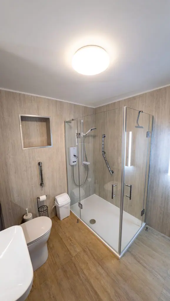 An accessible shower with corner entry doors to allow wider access - closed